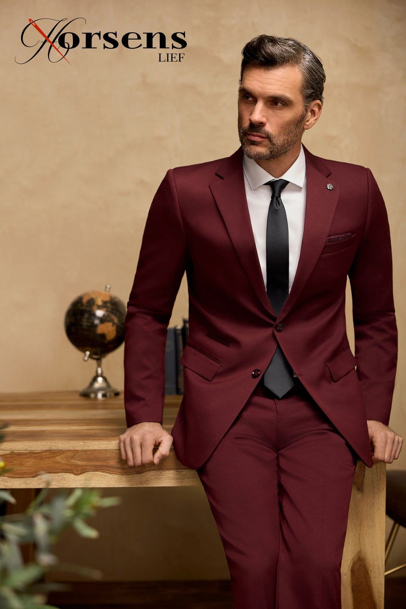 Deep burgundy suit with a black tie