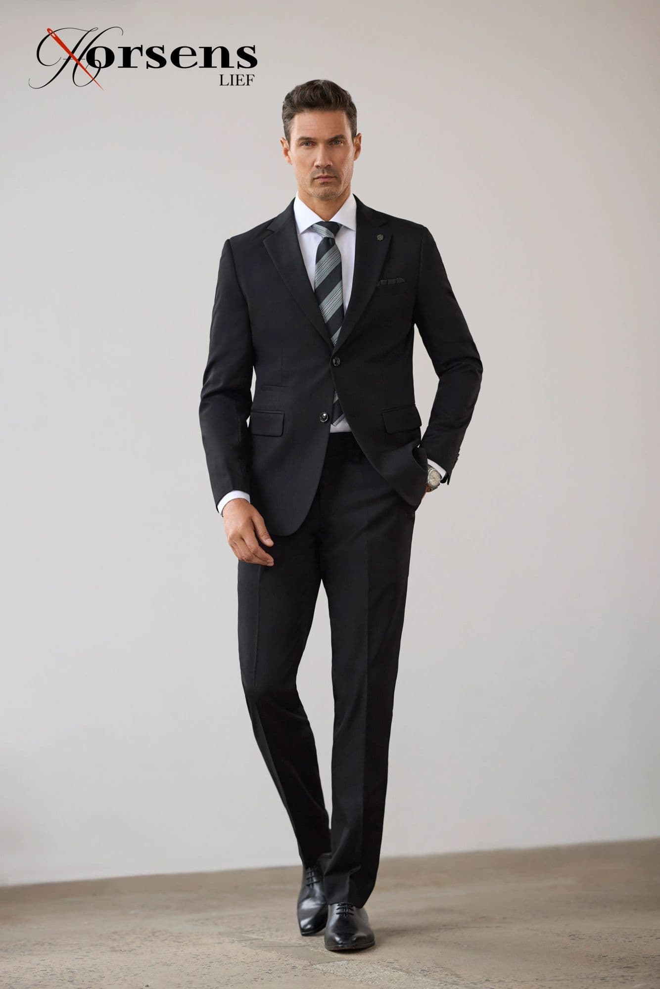 Black suit with a striped tie